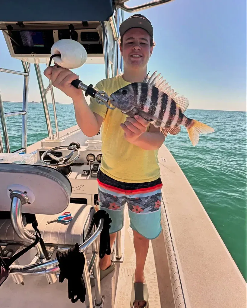Boy holding a sheepshead during a Sarasota fishing charter.